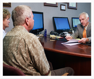 Three people sitting at a desk